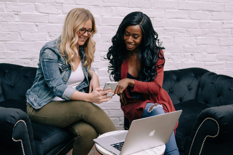 Storytelling strategist sitting with small business owner sharing the benefits of the importance of storytelling in marketing.